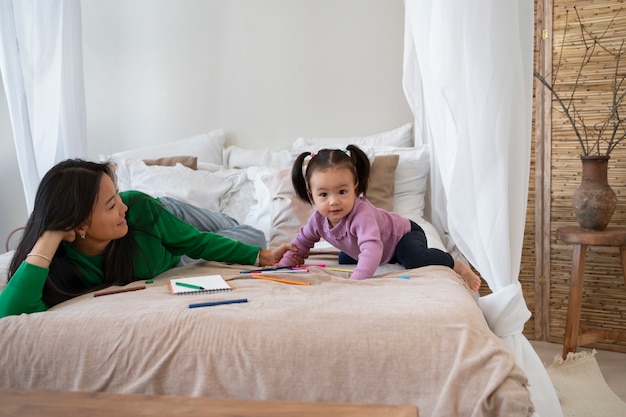 Free photo asian mother and daughter spending time together at home