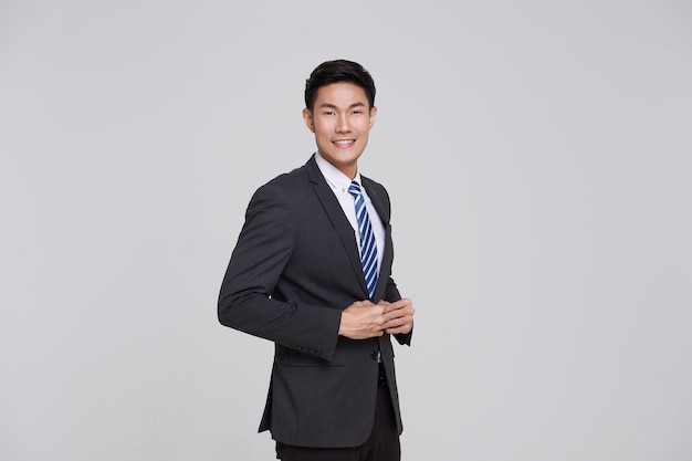 Free Photo asian portrait businessman in grey suit confident friendly face isolated on white background