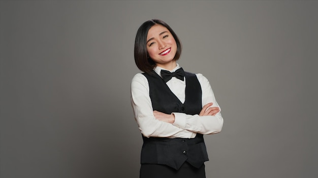 Free photo asian receptionist posing with arms crossed on camera