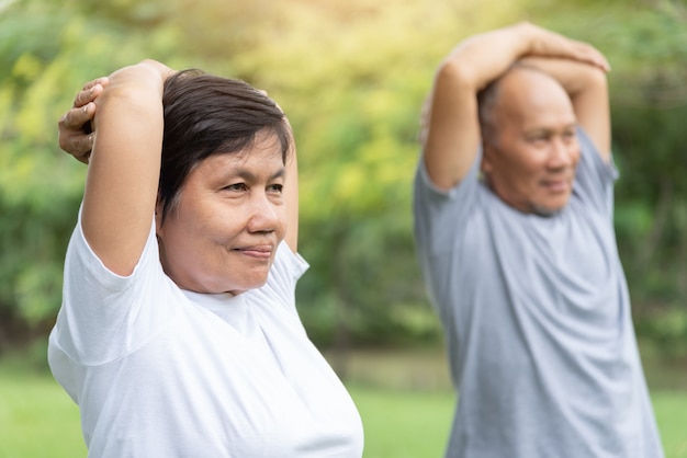 Premium Photo | Asian senior people stretching their arms before exercising.