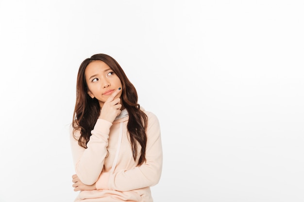 Asian thinking lady standing isolated