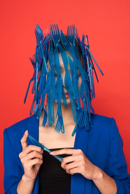 Asian woman being covered in blue plastic