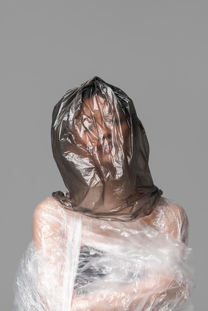 Asian woman being covered in plastic bags