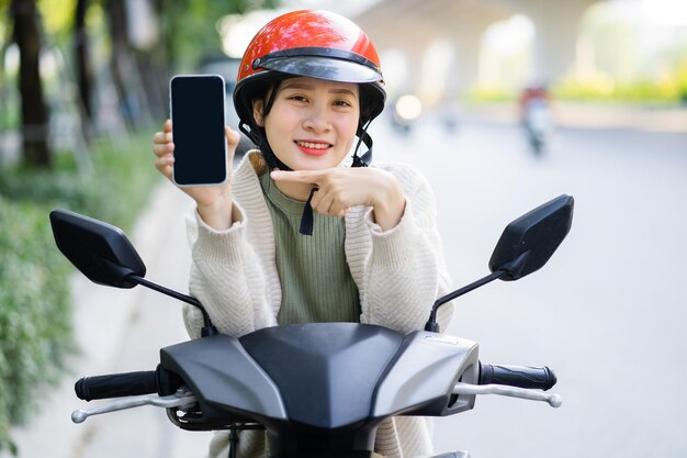 Asian woman driving a motorbike on her way to work
