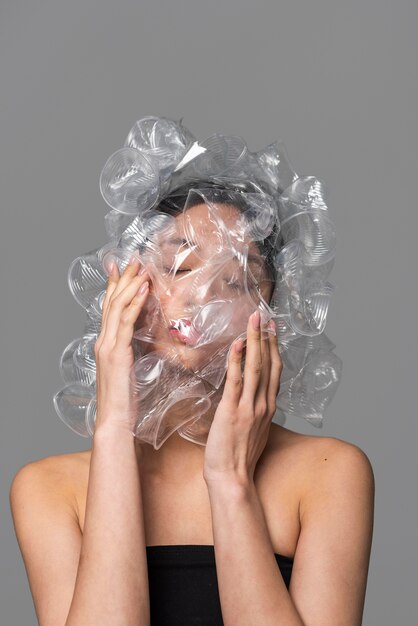 Asian woman face being covered in plastic cups