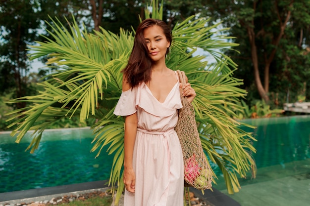 Asian woman holding eco friendly mesh shopper