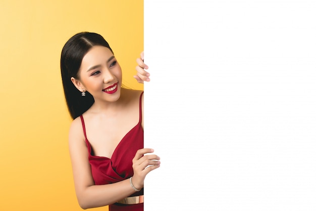 Asian woman holding and looking up to speech bubble with empty space for text