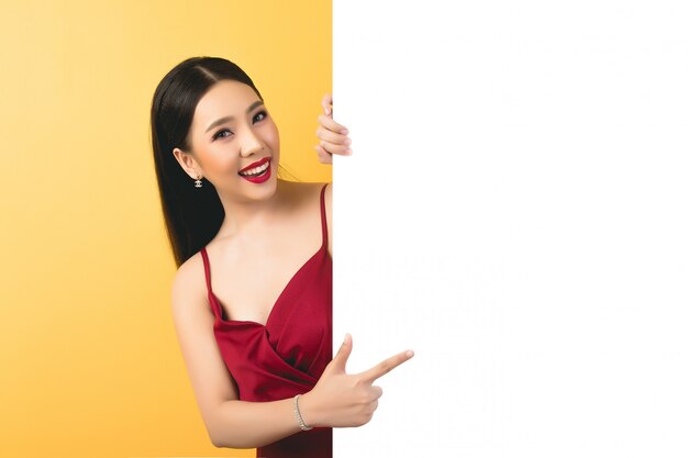 Asian woman holding and looking up to speech bubble with empty space for text