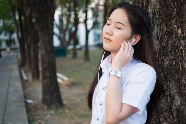 asian woman listening music