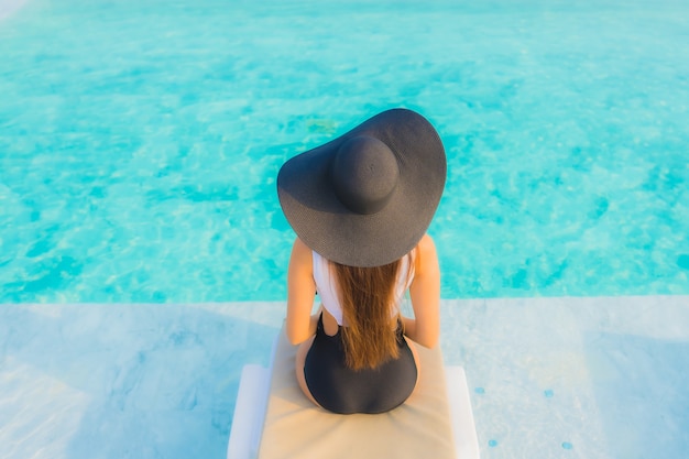 asian woman relaxing in swimming pool