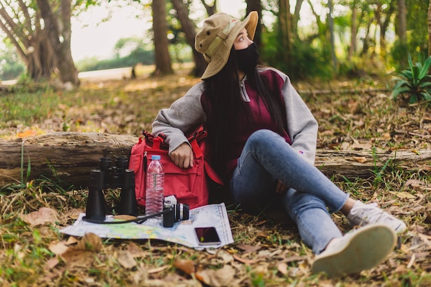 Free Photo asian woman tourist wearing face mask sitting and resting.