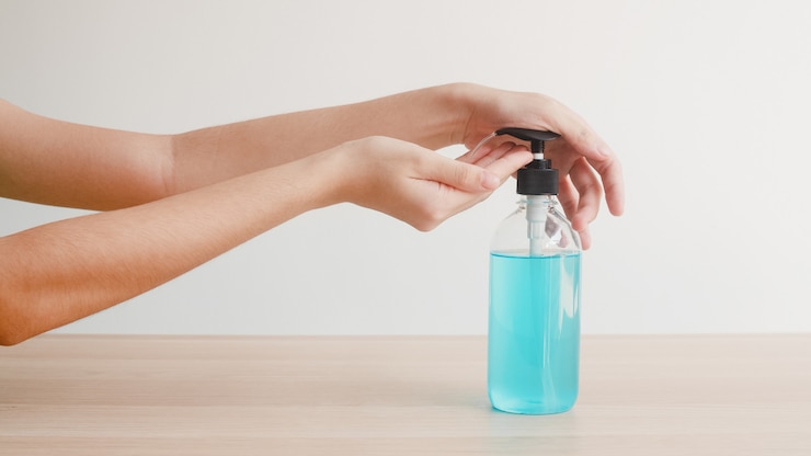 Free Photo asian woman using alcohol gel hand sanitizer wash hand for protect coronavirus. female push alcohol bottle to clean hand for hygiene when social distancing stay at home and self quarantine time.