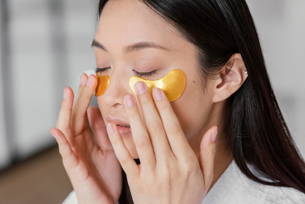 Asian woman using eye patches