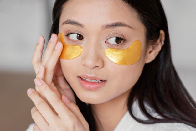 Asian woman using eye patches