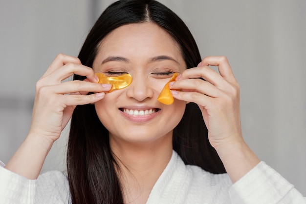 Asian woman using eye patches