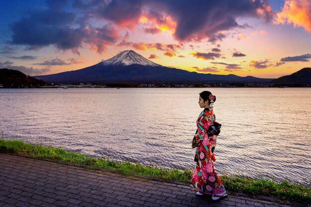 Asian woman wearing japanese traditional kimono at Fuji mountain