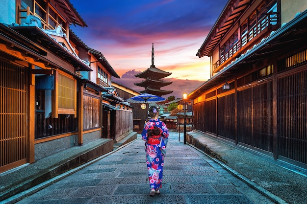 asian woman wearing japanese traditional kimono at yasaka pagoda and sannen zaka street in kyoto, japan.