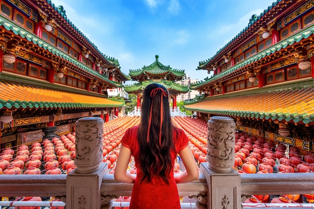 Asian woman wearing traditional Chinese dress at Sanfeng Temple in Kaohsiung, Taiwan.