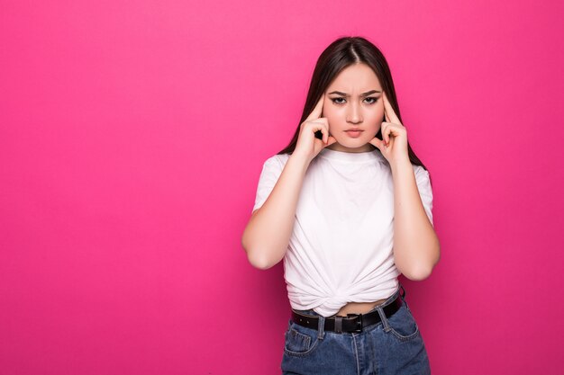 Asian woman with hands on head isolated on pink wall