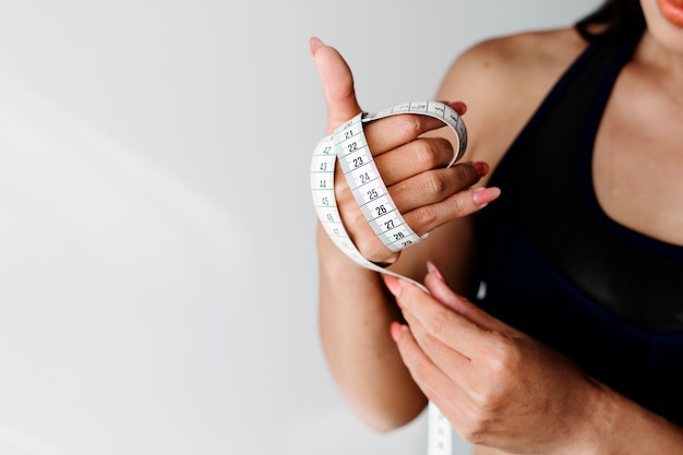 Asian woman with measuring tape