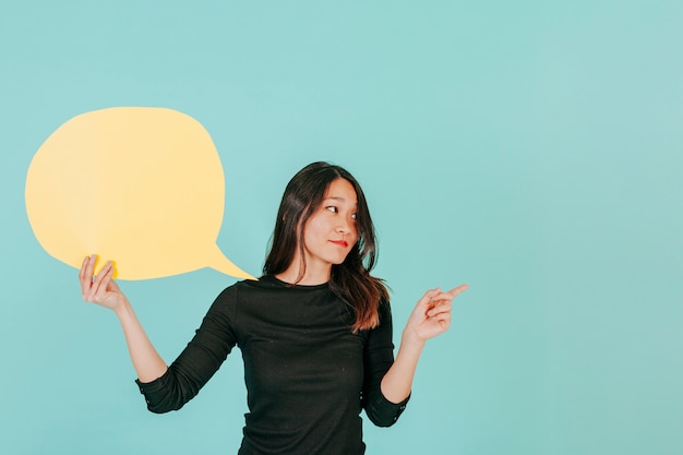 Asian woman with speech bubble pointing right