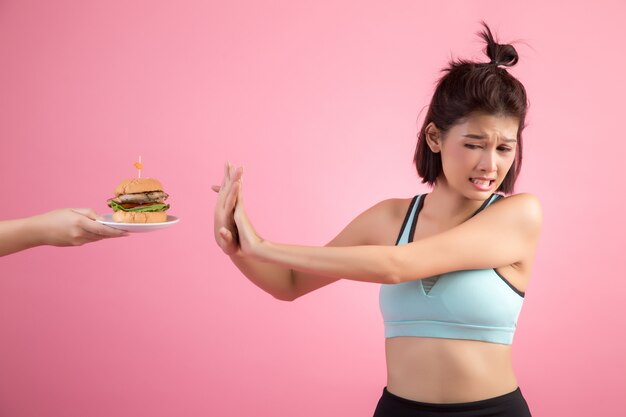 Asian women refuse fast food because of slimming on pink