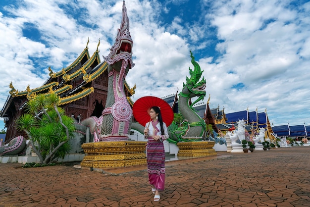 Asian women wearing Thai dress costume traditional according Thai culture at temple in Chiang Mai