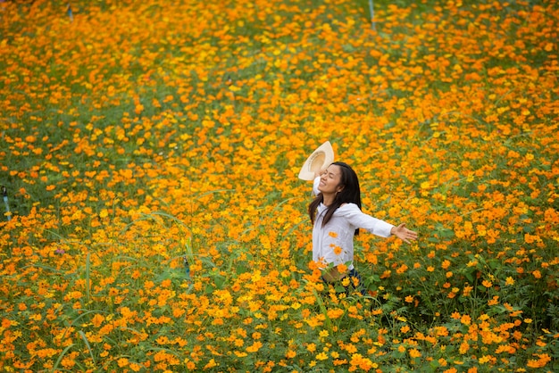 Asian women in yellow flower farm