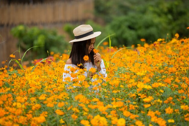 Asian women in yellow flower farm