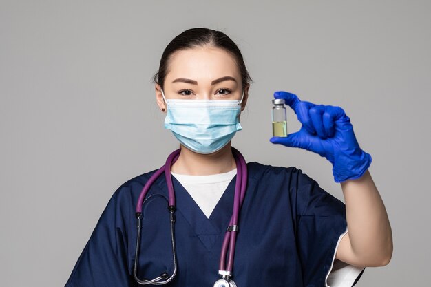 Asian young  female doctor holding vaccine vial