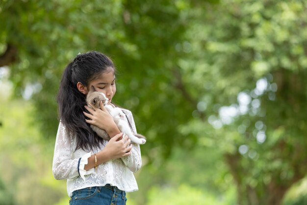 Asian young girl holding kittens in the park