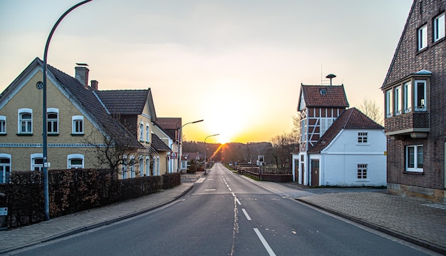 Asphalt road in the town and sunset rural landscape