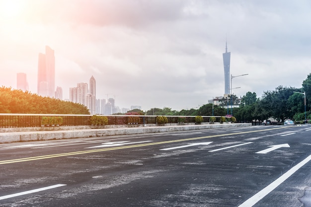 Asphalt road with office buildings in the distance