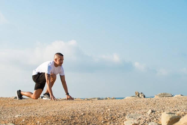 Aspirated man in starting position before race