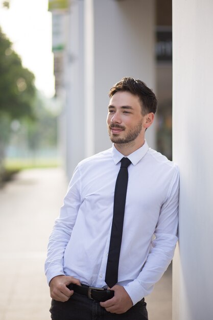 Aspirated young businessman resting outdoors