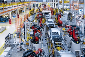 Assembly line production of new car automated welding of car body on production line robotic arm on car production line is working