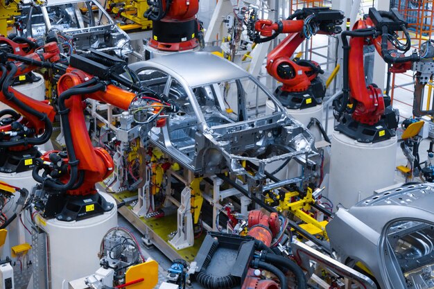 Assembly line production of new car Automated welding of car body on production line robotic arm on car production line is working