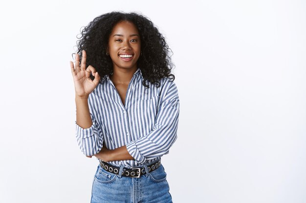 Assertive good-looking confident businesswoman relaxed showing okay ok gesture no problem, assured plan perfect, work done great, standing self-assured satisfied, recommending product