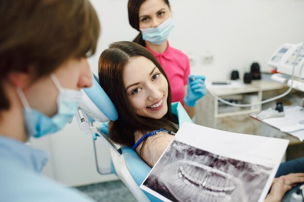 Assistant dentist and the patient in the clinic.