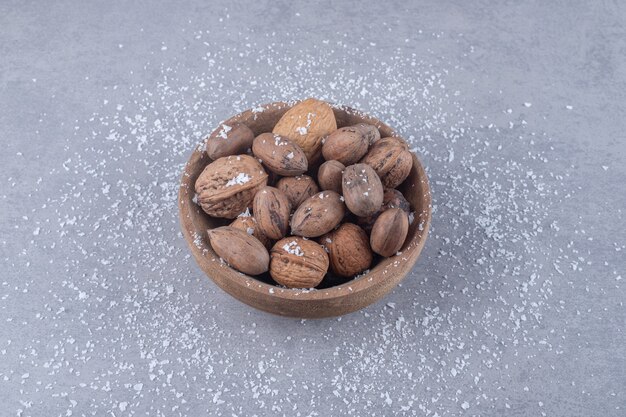 Assorted bowl of nuts on marble surface