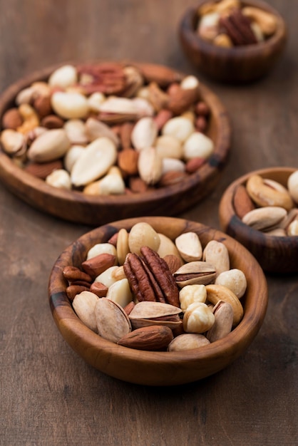 Assorted bowls of delicious nuts snack high view