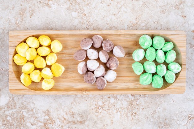 Assorted candies bundled in a small wooden tray 