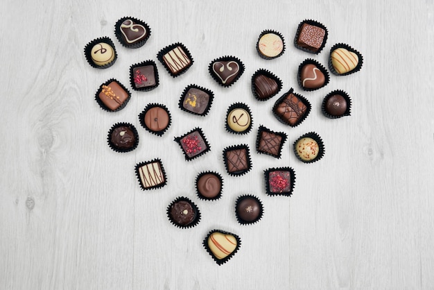 Free photo assorted chocolate sweets in shape of heart