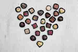 Free photo assorted chocolate sweets in shape of heart