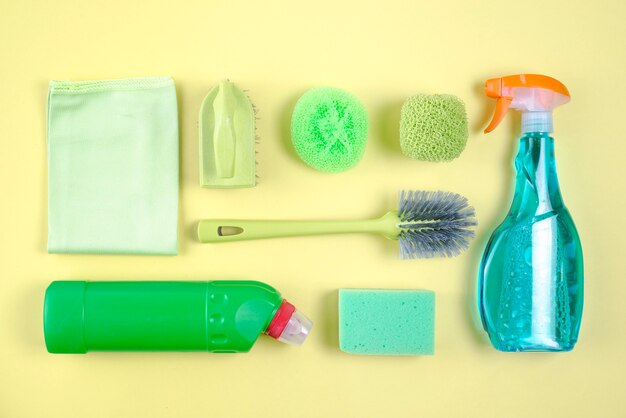 Assorted cleaning products on yellow background