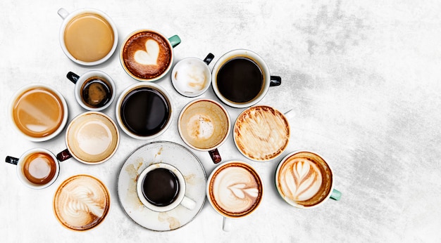 Assorted coffee cups on a textured background