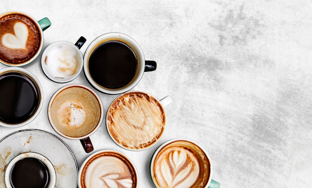 Assorted coffee cups on a textured background