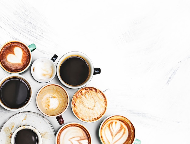 Assorted coffee cups on a textured