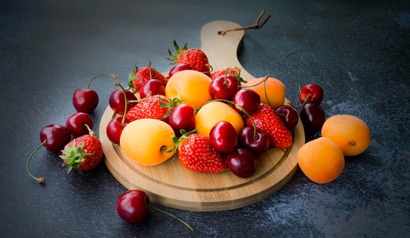  Assorted different fruits and berries strawberries cherries apricots Premium Photo