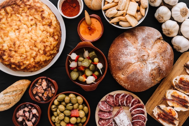 Assorted dishes near bread and garlic